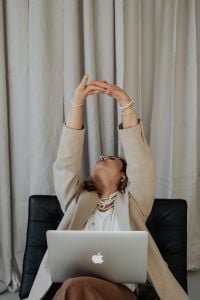 Kaboompics - Businesswoman Taking a Stretch Break beside Her Laptop