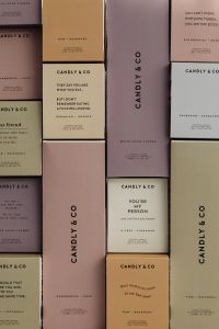 Kaboompics - Scented Candle Packaging Boxes in a Muted Color Flat Lay