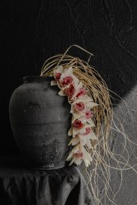 Kaboompics - White Orchids and Dried Grass in a Dark Ceramic Vase