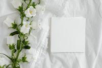 Kaboompics - Top-Down Blank Paper Stack Beside White Flowers on Rumpled Linen