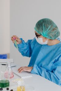 Kaboompics - Female Chemist Examining Sample Tube at Lab Bench