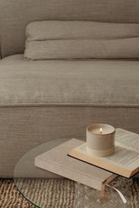 Kaboompics - Minimalist Living Room Scene with Candle, Open Book and Gray Sofa