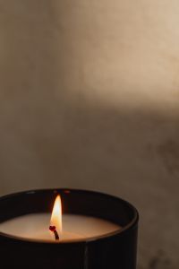Kaboompics - Lit Candle on Textured Concrete Ledge