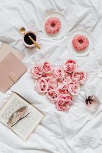 Kaboompics - Heart-Shaped Pink Rose Arrangement with Donuts and Coffee