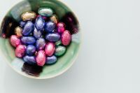 Kaboompics - Overhead Bowl of Colorful Foil Easter Eggs with Copy Space