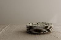 Kaboompics - Minimal Green Splatter Plate Stack on a Neutral Linen Table