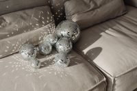 Kaboompics - Disco Balls on Gray Sofa with Colorful Party Light Reflections