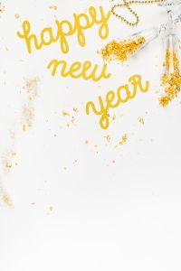 Kaboompics - Golden Happy New Year Background With Decorative Confetti
