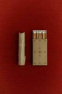 Kaboompics - Vintage Candle and Matchbox on Burgundy Fabric