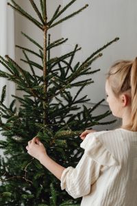 Kaboompics - Woman Decorating Christmas Tree at Home