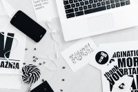 Kaboompics - Top View of Laptop, Phone, Earphones, Coffee Beans and Typography Cards