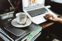 Kaboompics - Coffee And Laptop On Books At Home Office