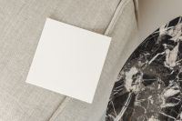 Kaboompics - Blank Square Card Mockup with Marble Corner on Beige Sofa