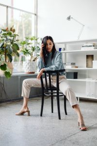 Kaboompics - Editorial Portrait of an Asian Woman Seated in a Bright Office