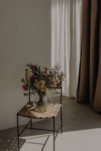 Kaboompics - Floor Vase Bouquet Beside White Sheer and Taupe Curtains