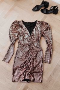 Kaboompics - gold rose sequin dresses and boots lie on a wooden parquet,