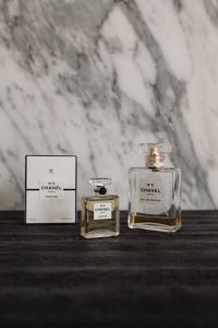 Kaboompics - Chanel No. 5 Perfume Bottles and Box on Dark Wood