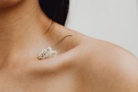 Kaboompics - Shoulder and Neck Detail with Delicate White Flower Sprig, Minimal Beauty Still Life