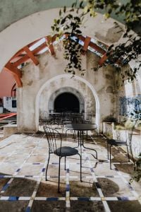 Kaboompics - Arched Courtyard Cafe with Garden Seating and Tile Details