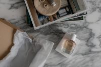 Kaboompics - Fragrance Bottle on Marble with Editorial Mood