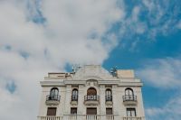 Kaboompics - Ornate Madrid Facade and Rooftop Cornice Beneath a Cloudy Blue Sky