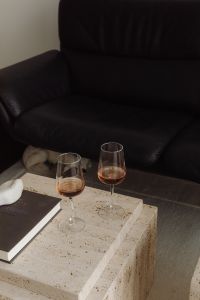 Kaboompics - Black Sofa and Travertine Tables with Open Book