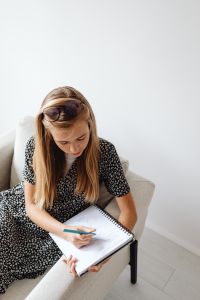 Kaboompics - Teenage Girl Writing in a Notebook at Home