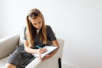 Kaboompics - Schoolgirl Writing Notes at Desk