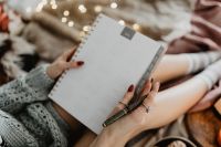 Kaboompics - Writing in a notebook lying in bed, with coffee, candles, and gingerbreads