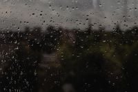 Kaboompics - Raindrops on Window With Blurred Garden Background