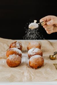 Kaboompics - Close-Up Gold Sieve Dusting Polish Doughnuts with Powdered Sugar