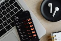 Kaboompics - Phone - stock exchange - charts - AirPods - laptop