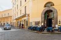 Kaboompics - Italian Street Restaurant With Blue Tablecloths And Stone Archway