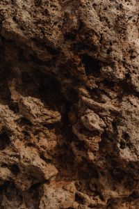Kaboompics - Dark Pitted Rock with Natural Holes and Cavities
