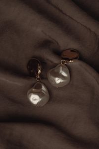 Kaboompics - Pearl Drop Earrings with Gold Studs on Dark Satin