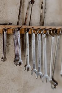Kaboompics - Hanging Wrenches with Blank Wall Copy Space Above the Rail