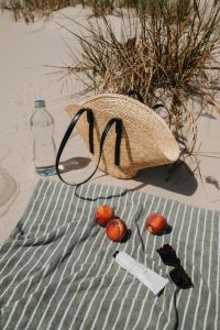 Kaboompics - Straw Beach Bag, Water Bottle and Peaches on a Towel