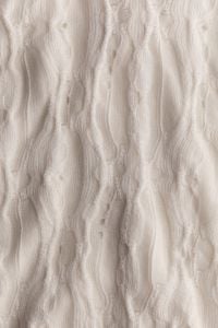 Kaboompics - Soft Cream Knitted Pattern With Raised Texture
