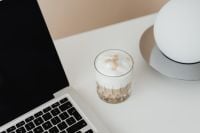 Kaboompics - Laptop and a glass of Cafe Latte on the desk