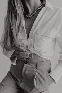 Kaboompics - Black and White Woman in White Shirt Holding a Glass