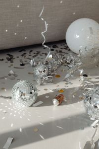 Kaboompics - Happy New Year Balloon with Silver Disco Balls and Scattered Confetti