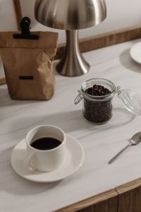 Kaboompics - Coffee Beans in a Glass Jar with Paper Coffee Bag