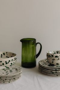 Green Splatter Tableware and Sculptural Pitchers in Neutral Still Life Settings