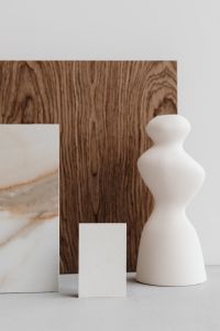Kaboompics - Blank Business Card with Sculptural White Vase and Marble Tile on Dark Wood, Branding Mockup
