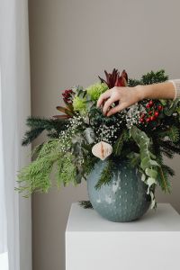 Kaboompics - Hand Adding Ornament to Christmas Greenery