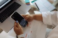 Kaboompics - Hands Typing a Phone Note at Work Desk