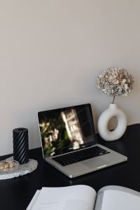 Kaboompics - Home Office Laptop and Black Candle with Sculptural White Vase, Neutral Desk Decor