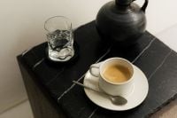 Kaboompics - Overhead Coffee Cup and Spoon on Black Slate Table
