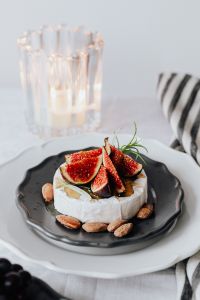 Kaboompics - Close-Up Fig-Topped Camembert with Glass Candleholder and Napkin