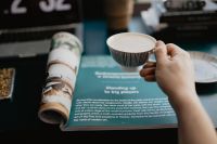 Kaboompics - Magazine Reading Setup with Coffee and Rolled Pages